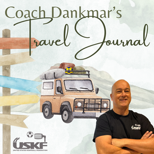 Coach Dankmar's Travel Journal: Coach Dankmar smiling with crossed arms in front of an illustration showing a packed car and a signpost